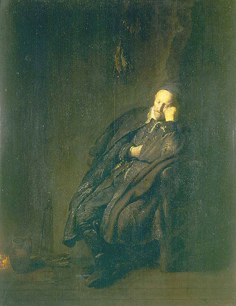 An old man asleep by a fire